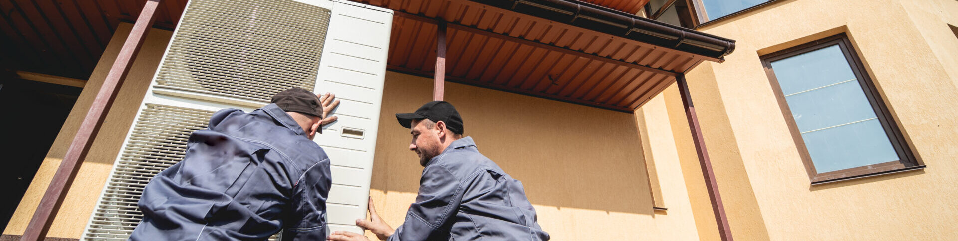 Hvac Technicians Servicing Home Heating And Cooling System