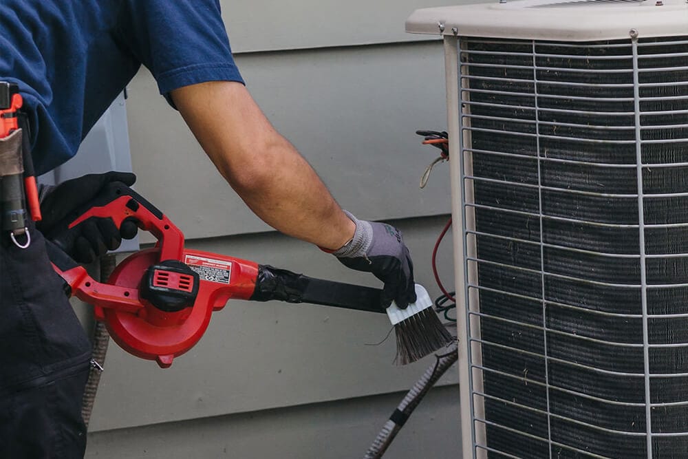 man cleaning ac unit