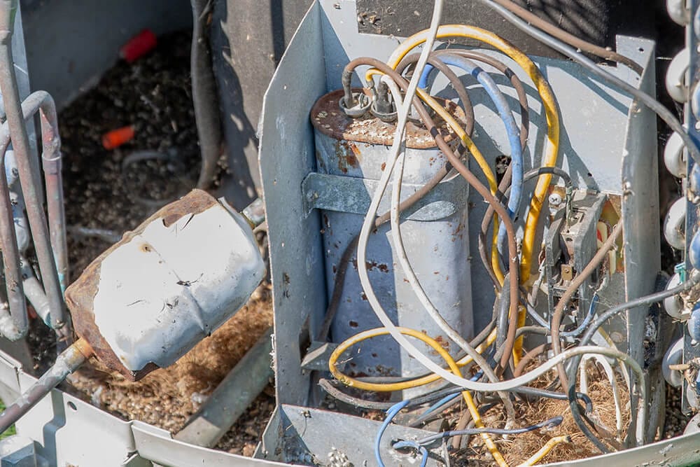 Close-up of damaged air conditioning system components during repair