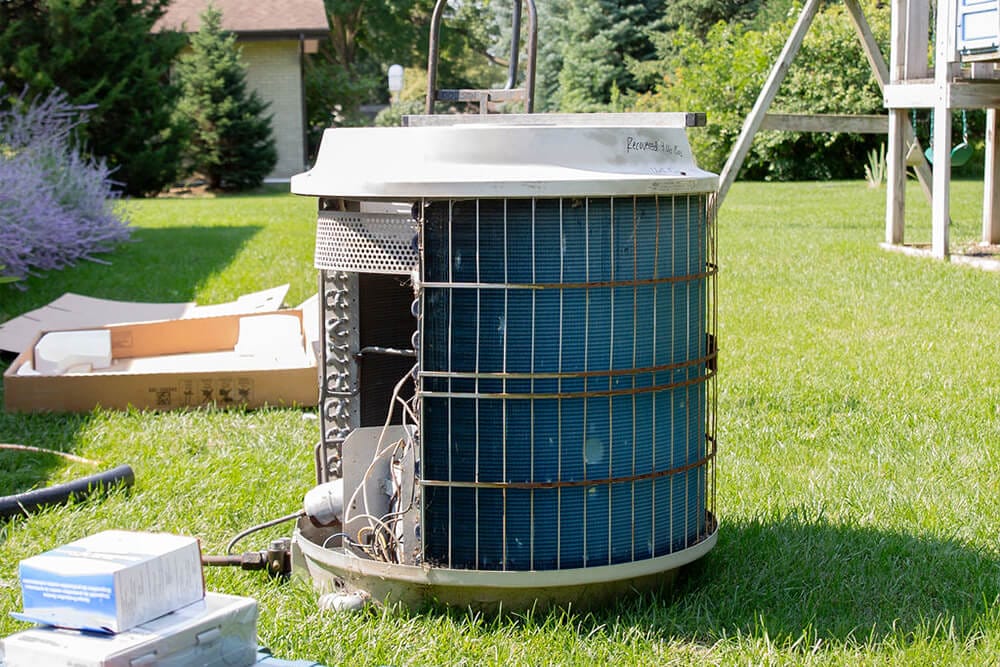 Residential AC condenser unit being serviced by HVAC company in DeKalb