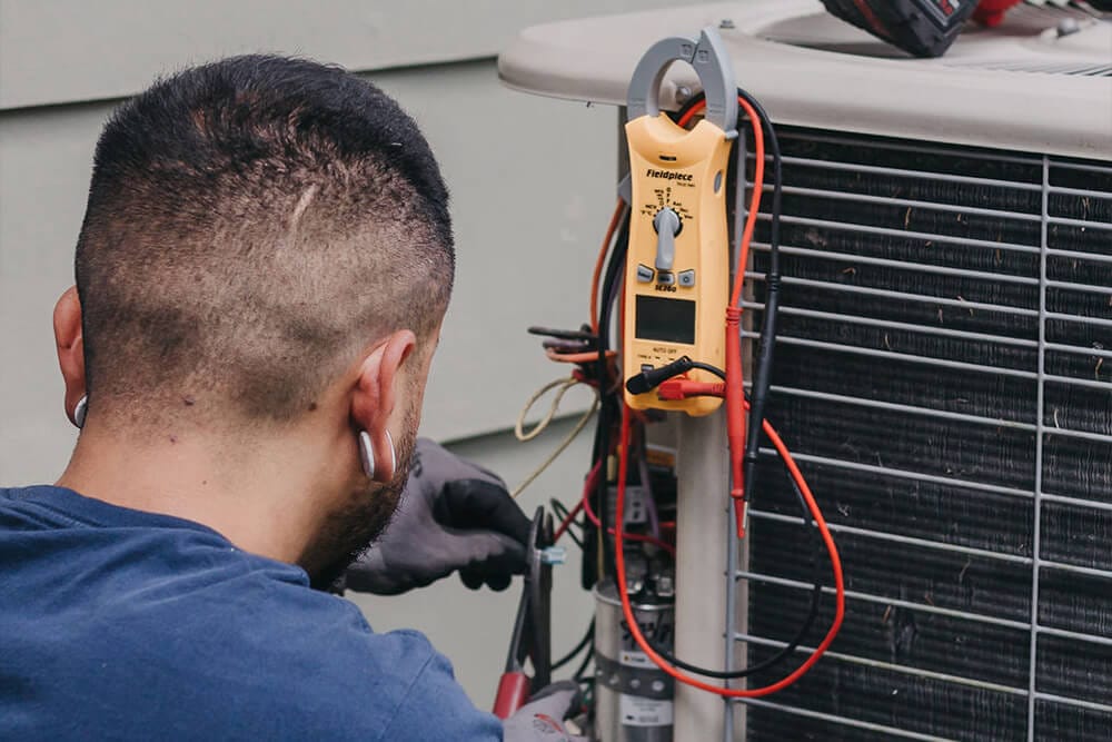 man checking condition of ac