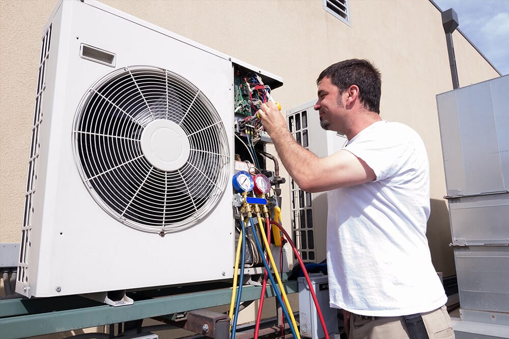 man installing a ductless mini split system