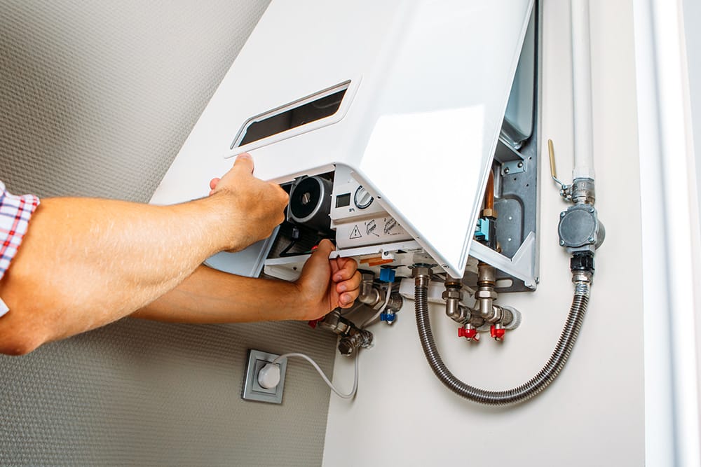 man opening a heater to see interior