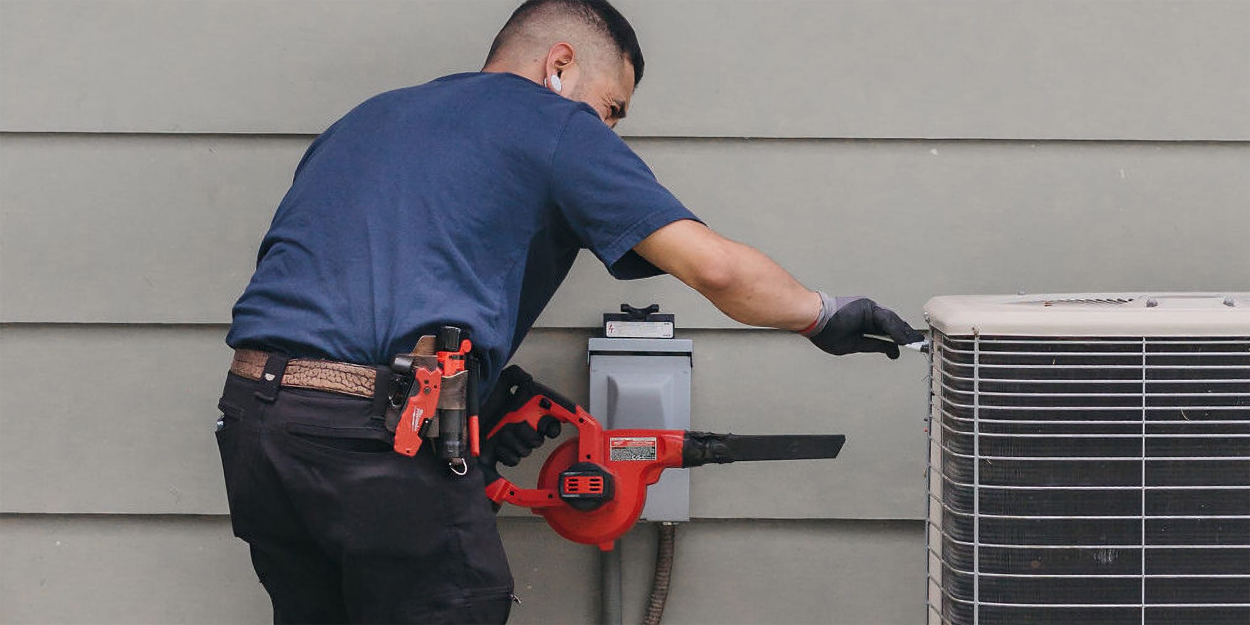 man installating ac an doing some clean up