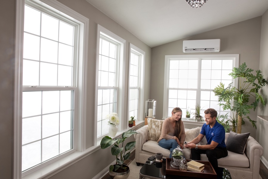 Woman and Carrier salesman in sunroom with newly installed ductless system.