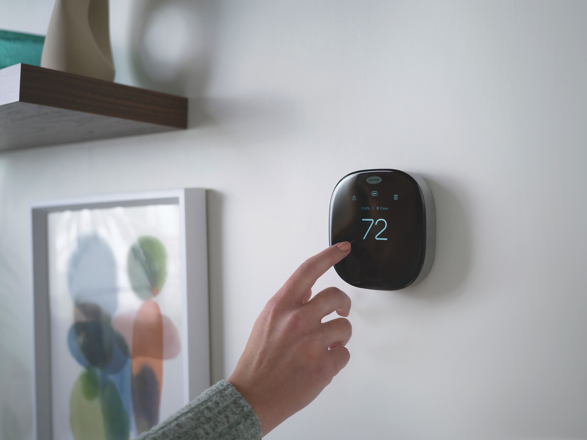 Someone changing settings on Ecobee smart thermostat.