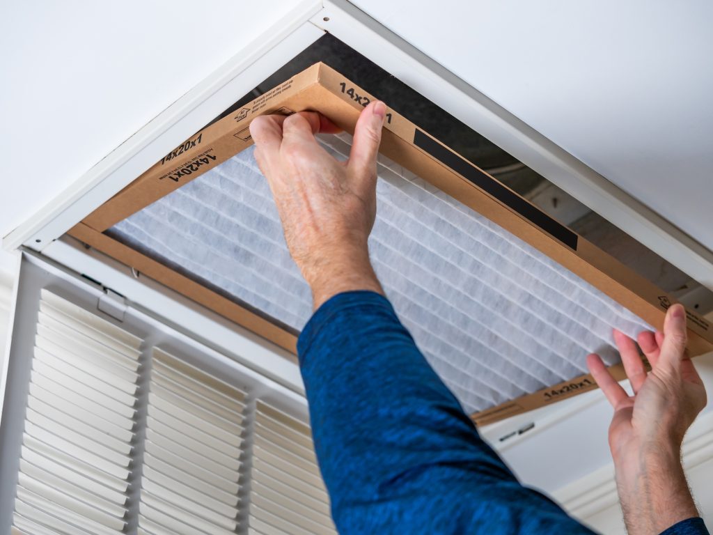 Man replacing dirty filter for better air quality