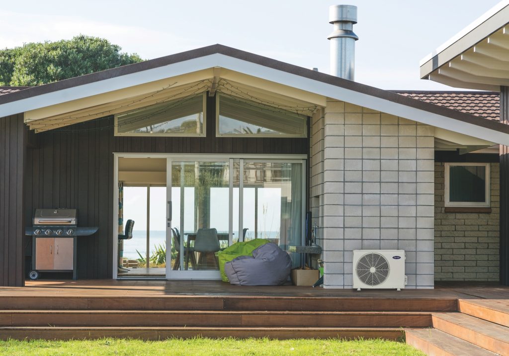 Outdoor view of home with their ductless system showing.