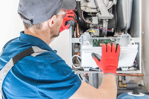 man installing new furnace