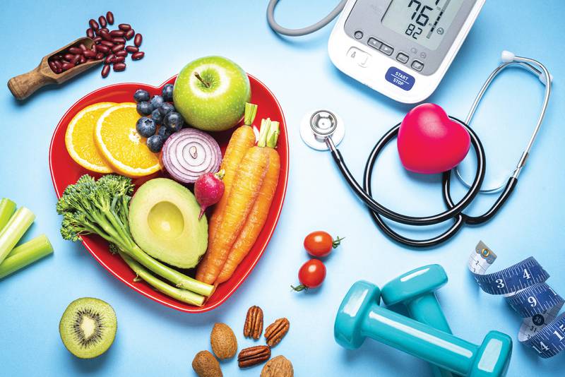 heart shaped bowl full of vegetables and fruits and a heart monitor